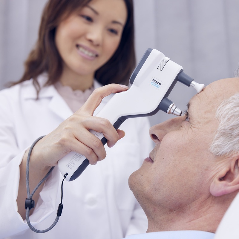 Doctor measuring IOP on reclined patient with IC200