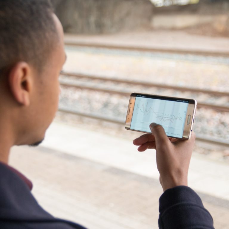 Patient reviewing iCare HOME2 IOP data on mobile phone via iCare PATIENT2 app